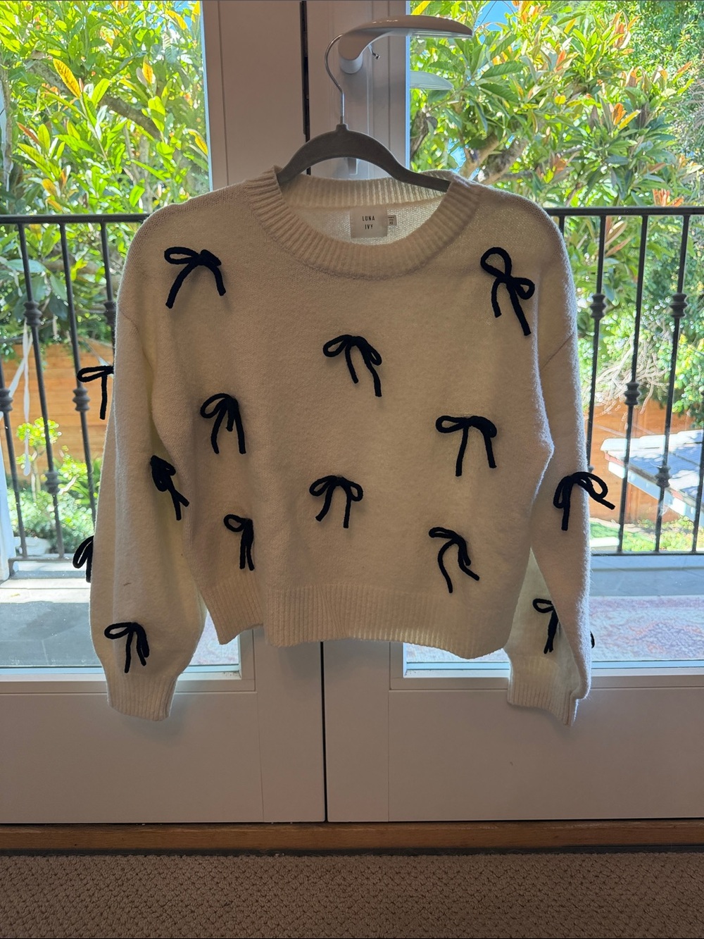 Cream Crewneck Sweater with Black Bow Appliqués
